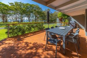a patio with a table and chairs on a deck at Sandpiper 4 in Smiths Lake +13 photos