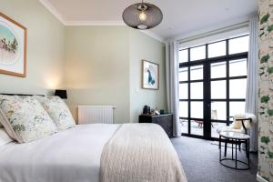 a bedroom with a bed and a large window at The Deco Retreat in Hawera