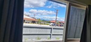 a window with a view of a street at Kiwi Cove Motel in Taupo