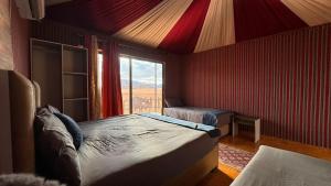 a bedroom with a large bed and a window at elan luxury camp in Disah
