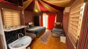 a bathroom with a sink and a bed in a room at elan luxury camp in Disah