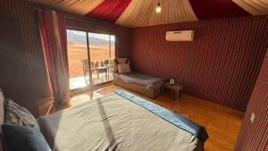 a bedroom with a bed and a chair and a window at elan luxury camp in Disah
