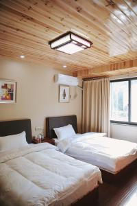 Ένα ή περισσότερα κρεβάτια σε δωμάτιο στο The Zhang B&B