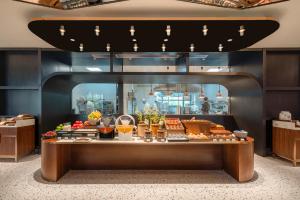 a buffet line with food on display in a restaurant at Atour Hotel Shanghai City Center ATHOUSE嘉邸 in Shanghai