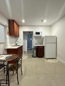 a kitchen with a refrigerator and a table and chairs at Miramar's Studio in Miramar +15 photos
