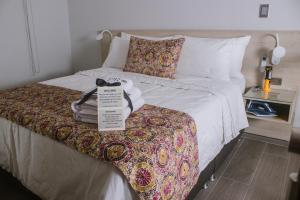 a hotel room with a bed with a sign on it at Aparta Hotel Loft 1985 Awaliba in Puerto Gaitán