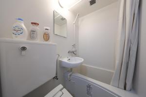 a white bathroom with a sink and a shower at Tsurumai Nagoya Stay in Nagoya +44 photos