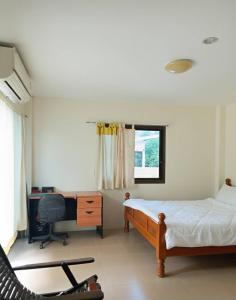 a bedroom with a bed and a desk and a computer at KODO Guest House in Nathon Bay +14 photos