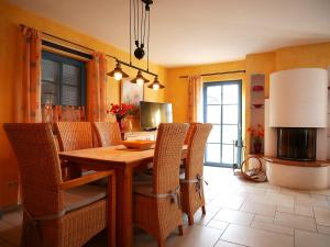 a dining room with a wooden table and chairs at Mohnblume in Am Schwarzen Busch