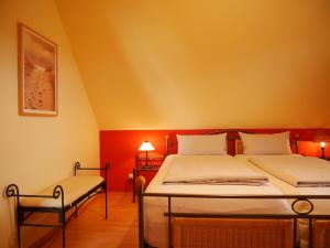 a bedroom with two beds and a chair at Mohnblume in Am Schwarzen Busch