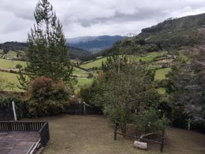 a garden with trees and a view of a valley at Chalet CAJIK Project, tipo Nordico in Cajicá