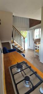 a stove top oven in a kitchen with a table at Duplex Playa Mansa in Mina Clavero