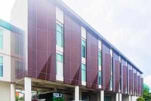 a large building with a purple and white facade at Hotel Training Center UIN Mataram in Mataram