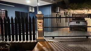 a black fence with a light in front of it at Greeny Homestay in Muar