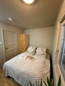 a bedroom with a bed with a white comforter at Koselig feriehus ved sjøen - Skjevikstranden in Steinkjer +24 photos