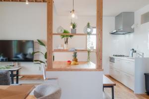 a kitchen with a counter with plants on it at タイガーMiyako in Miyako-jima