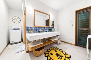 a bathroom with a sink and a mirror at タイガーMiyako in Miyako-jima +58 photos