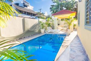 a swimming pool in front of a house at Villa Lionisia in Puerto Plata