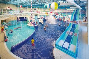 a large indoor water park with people in it at Luxury 3 Bedroom Caravan Near Edinburgh in Port Seton