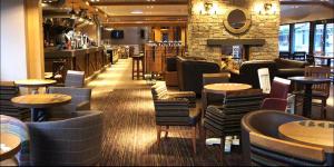 a restaurant with tables and chairs and a bar at Luxury 3 Bedroom Caravan Near Edinburgh in Port Seton