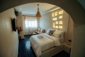 a bedroom with a large white bed in a room at Surf Lodge Tamraght in Tamraght Ouzdar +187 photos