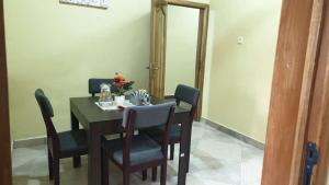 a dining room with a table and four chairs at Grace View Villa in Trofwi
