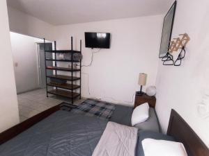 a bedroom with a bed and a tv on the wall at Casa Capuchina in Querétaro