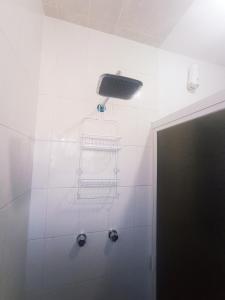 a shower with two baskets and a light on the wall at Casa Capuchina in Querétaro +17 photos