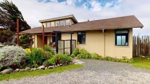 a house with a gravel driveway in front of it at Tideaway Private Hot Tub and Expansive Ocean View in Fort Bragg