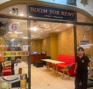 a woman standing in front of a room for rent store at Luxus Grand Hotel in Patong Beach