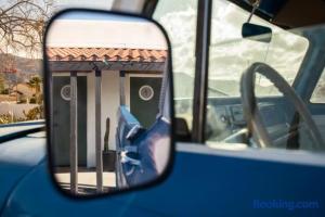 a side view mirror of a blue bus at Ramsey 29 in Twentynine Palms