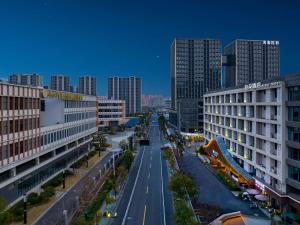 a view of a city street with tall buildings at Atour Hotel Canal Hangzhou in Hangzhou