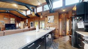 a kitchen with wooden walls and a large counter top at Tideaway Private Hot Tub and Expansive Ocean View in Fort Bragg +37 photos