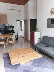 a living room with a couch and a table at Adah 786 Villa Syariah in Krian
