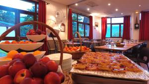 a table with food and fruit on it in a restaurant at VVF Saint-Lary-Soulan Hautes-Pyrénées in Saint-Lary-Soulan