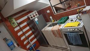 a small kitchen with a stove and a sink at Triplex waltito in San Clemente del Tuyu