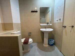 a bathroom with a toilet and a sink at Luxus Grand Hotel in Patong Beach