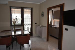 a kitchen and dining room with a table and chairs at A casa di Gina in Airasca