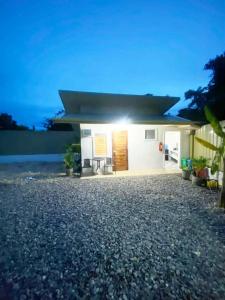 a small white house with the sun shining on it at Eco Homes in Panglao Island