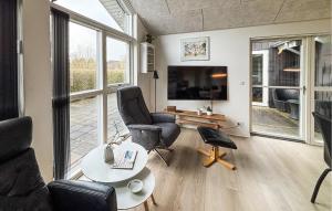 a living room with two chairs and a tv at Lovely Home In Haderslev With Sauna in Haderslev
