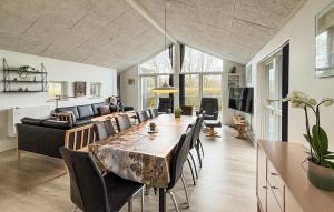 a living room with a large table and chairs at Lovely Home In Haderslev With Sauna in Haderslev