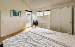 a bedroom with a bed and a chair in it at Lovely Home In Haderslev With Sauna in Haderslev