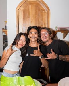 a group of three people posing for a picture at Lost Inn Kuta Capsule Hostel in Kuta Lombok