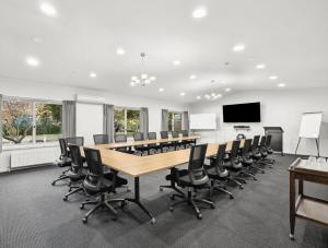 a conference room with a long table and chairs at Lancefield Guest House in Lance Field