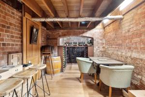a bar with tables and chairs and a wine cellar at Lancefield Guest House in Lance Field