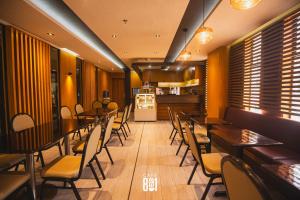 a restaurant with tables and chairs and a kitchen at Hotel 801 in Cagayan de Oro