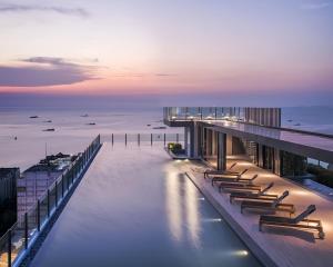 a row of chairs sitting on a building over water at The Base Central Pattaya in Pattaya