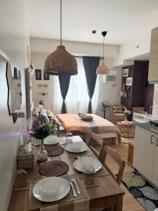 a kitchen and living room with a dining room table at Baan Mai Condo Staycation in Biñan