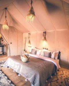 a bedroom with a bed in a tent at Authentic Desert Luxury Camp in Merzouga
