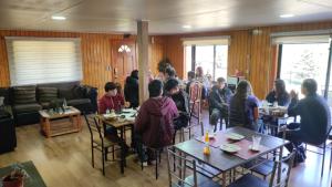 a group of people sitting at tables in a room at Hospedaje Fer-Mar in Castro +12 photos